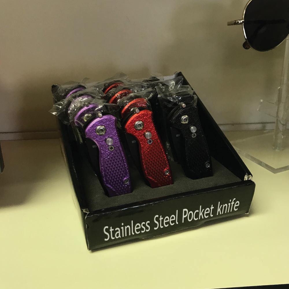 Assorted 12-Piece Stainless Steel Folding Knives neatly arranged in a display case.