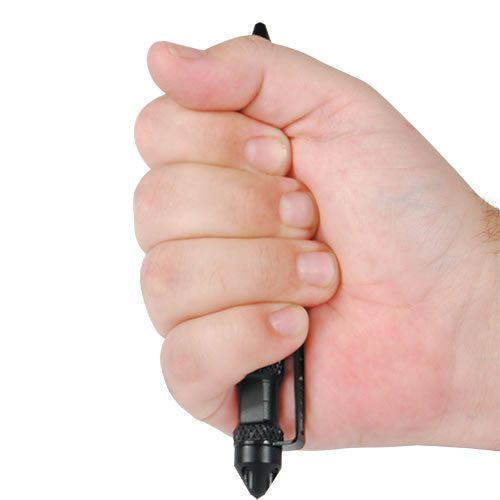 Close-up of someone holding a black tactical pen placed on a white background.