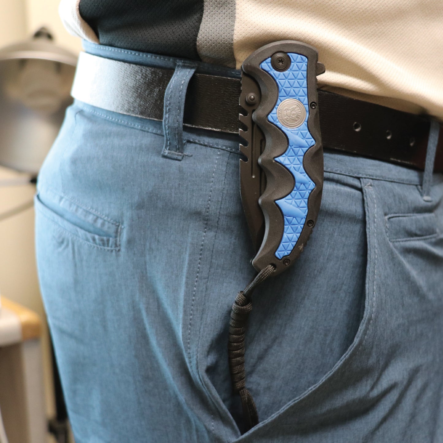 Someone carrying Military Medallion 8.5" Rescue Knife - sturdy folding rescue knife featuring a military medallion design, equipped with a seatbelt cutter and glass breaker for emergencies.