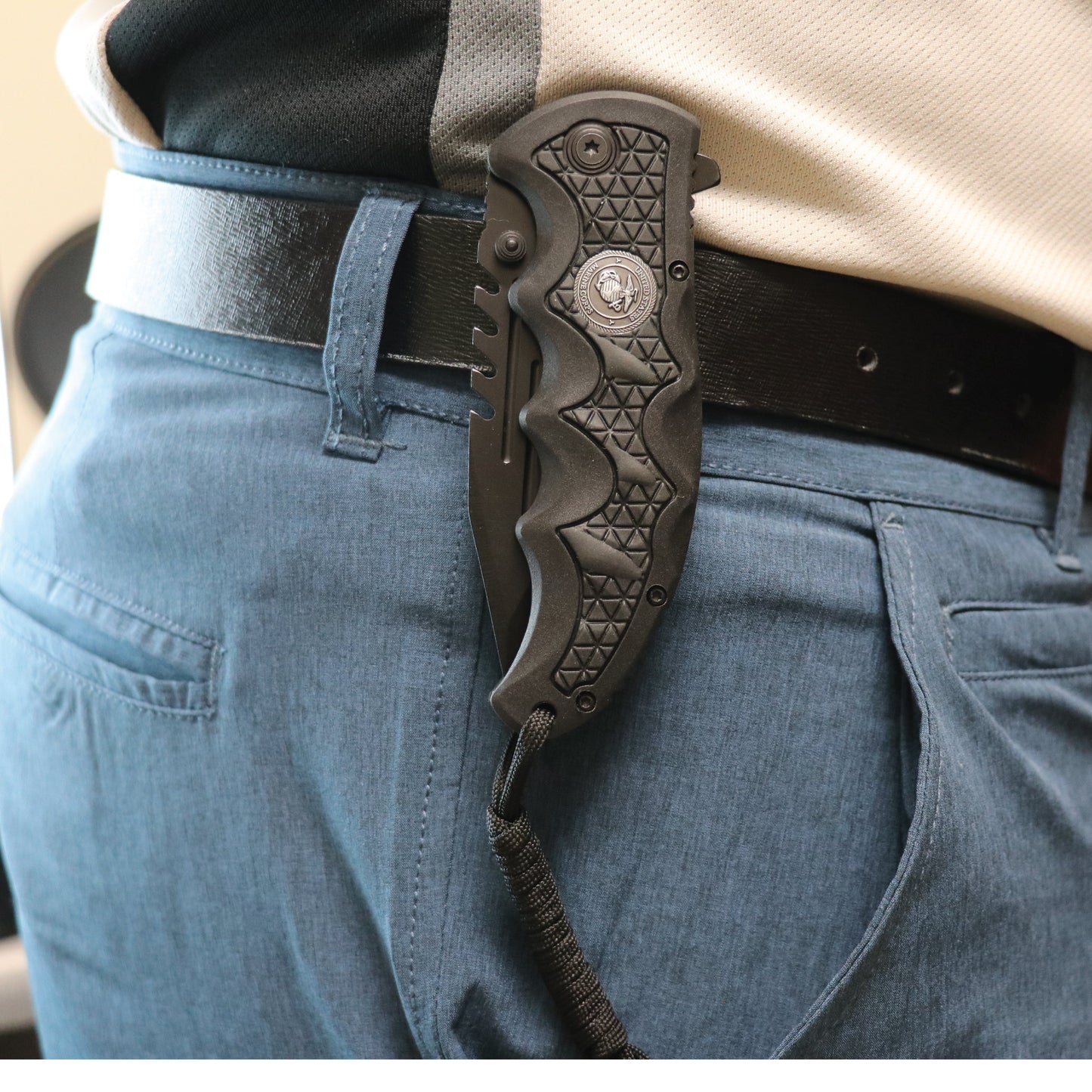 Someone carrying Military Medallion 8.5" Rescue Knife - sturdy folding rescue knife featuring a military medallion design, equipped with a seatbelt cutter and glass breaker for emergencies.