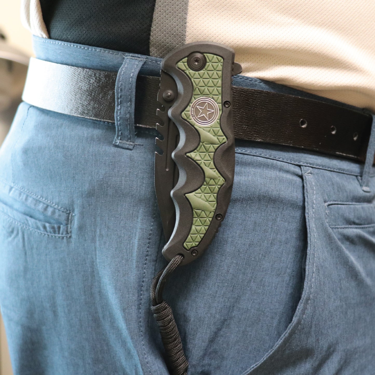 Someone carrying Military Medallion 8.5" Rescue Knife - sturdy folding rescue knife featuring a military medallion design, equipped with a seatbelt cutter and glass breaker for emergencies.