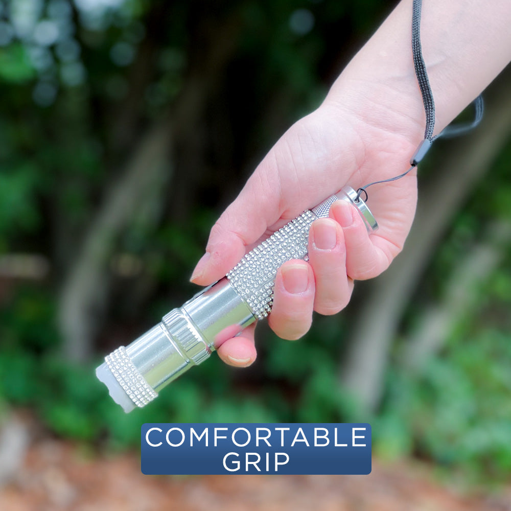 Someone holding Rhinestun 75,000,000 Stun Flashlight - stylish and powerful self-defense flashlight featuring rhinestone accents and a high-volage stun gun for discreet personal protection.