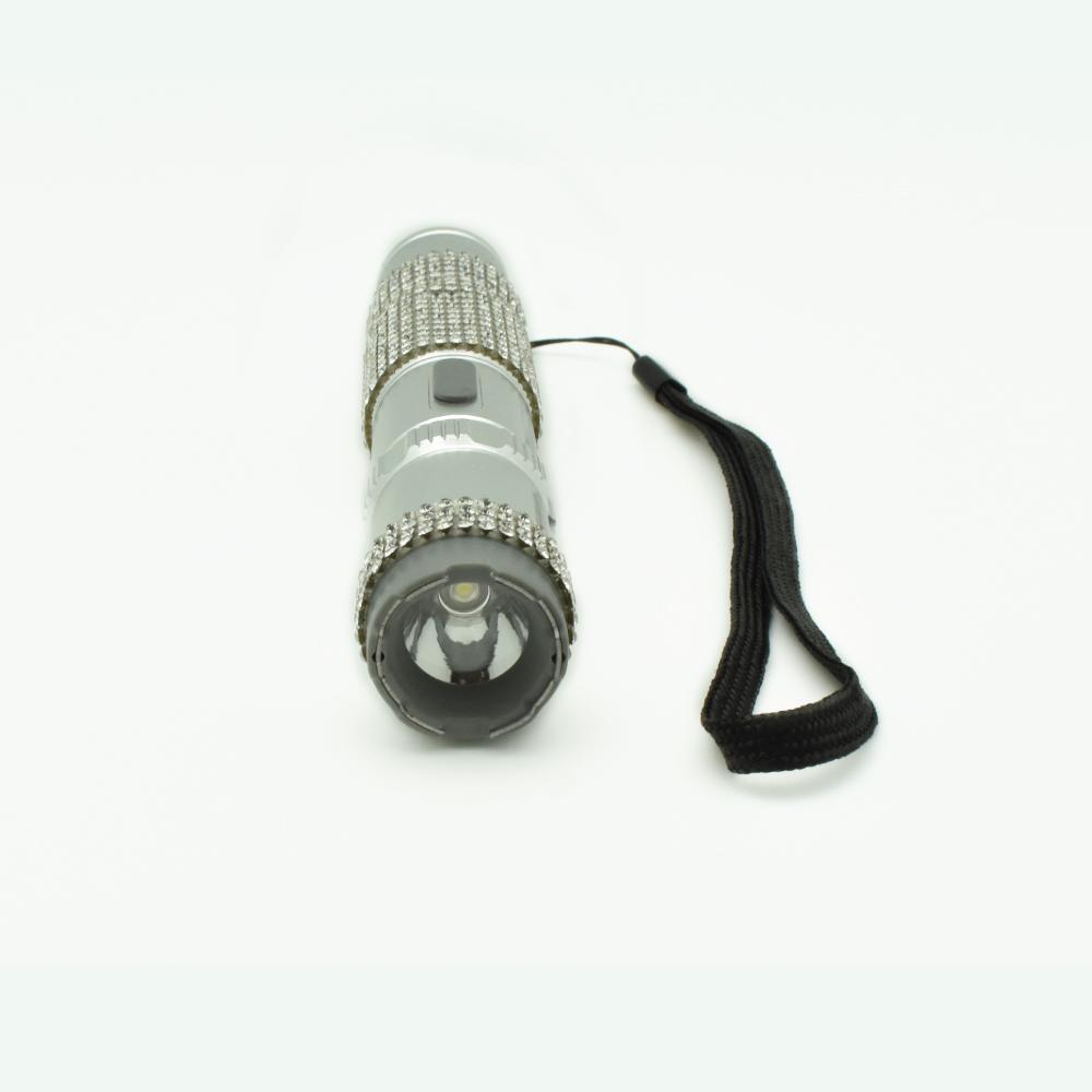 Rhinestun 75,000,000 Stun Flashlight - stylish and powerful self-defense flashlight featuring rhinestone accents and a high-volage stun gun for discreet personal protection, in white background.