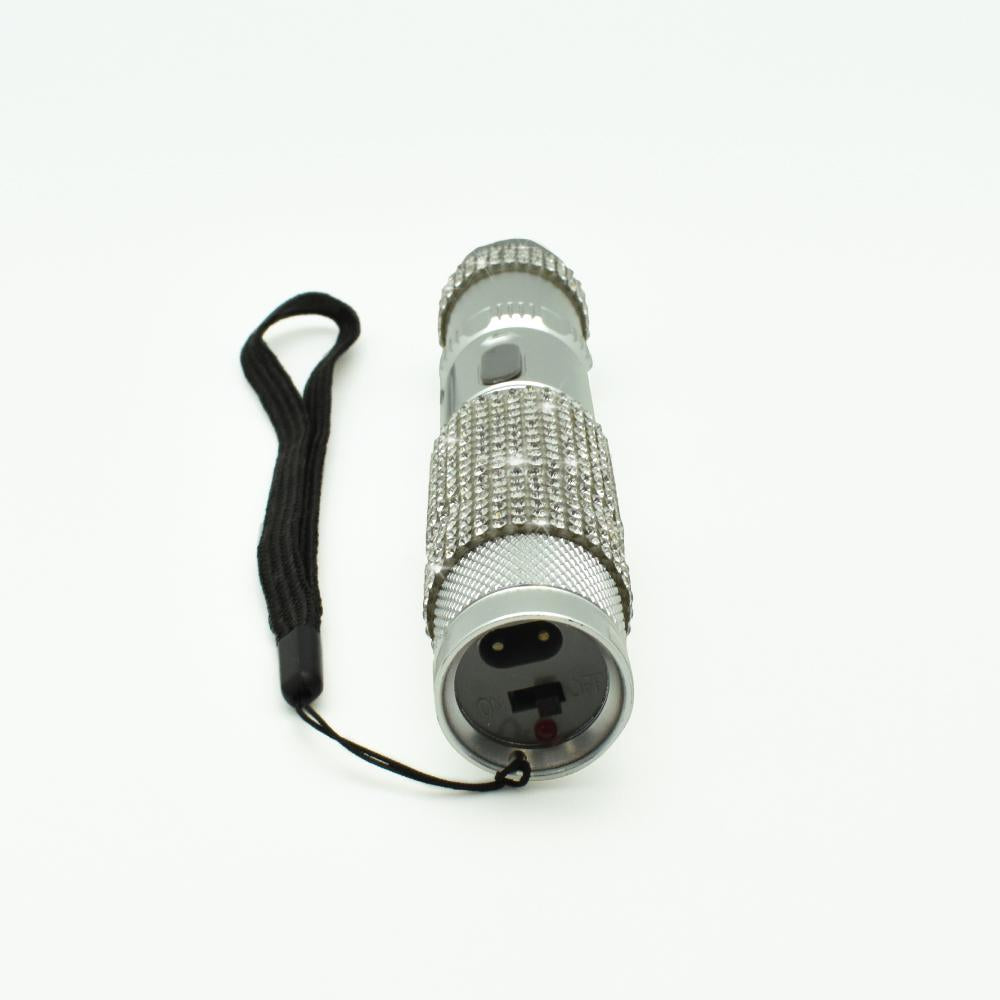 Rhinestun 75,000,000 Stun Flashlight - stylish and powerful self-defense flashlight featuring rhinestone accents and a high-volage stun gun for discreet personal protection, in white background.