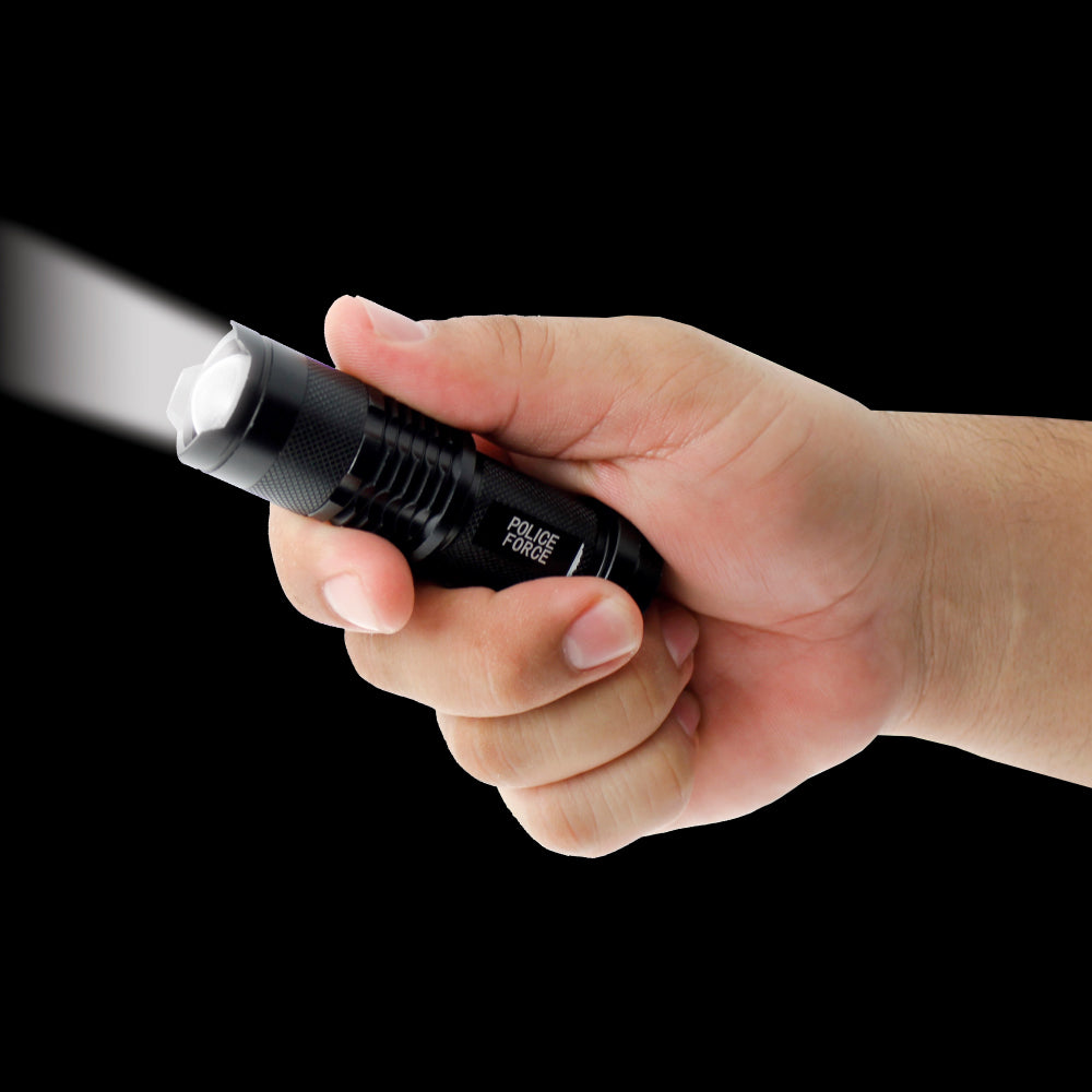 Someone holding Tactical Q5 LED Flashlight – compact and powerful flashlight featuring a Q5 LED for high brightness and reliable performance in tactical situations, in dark background.