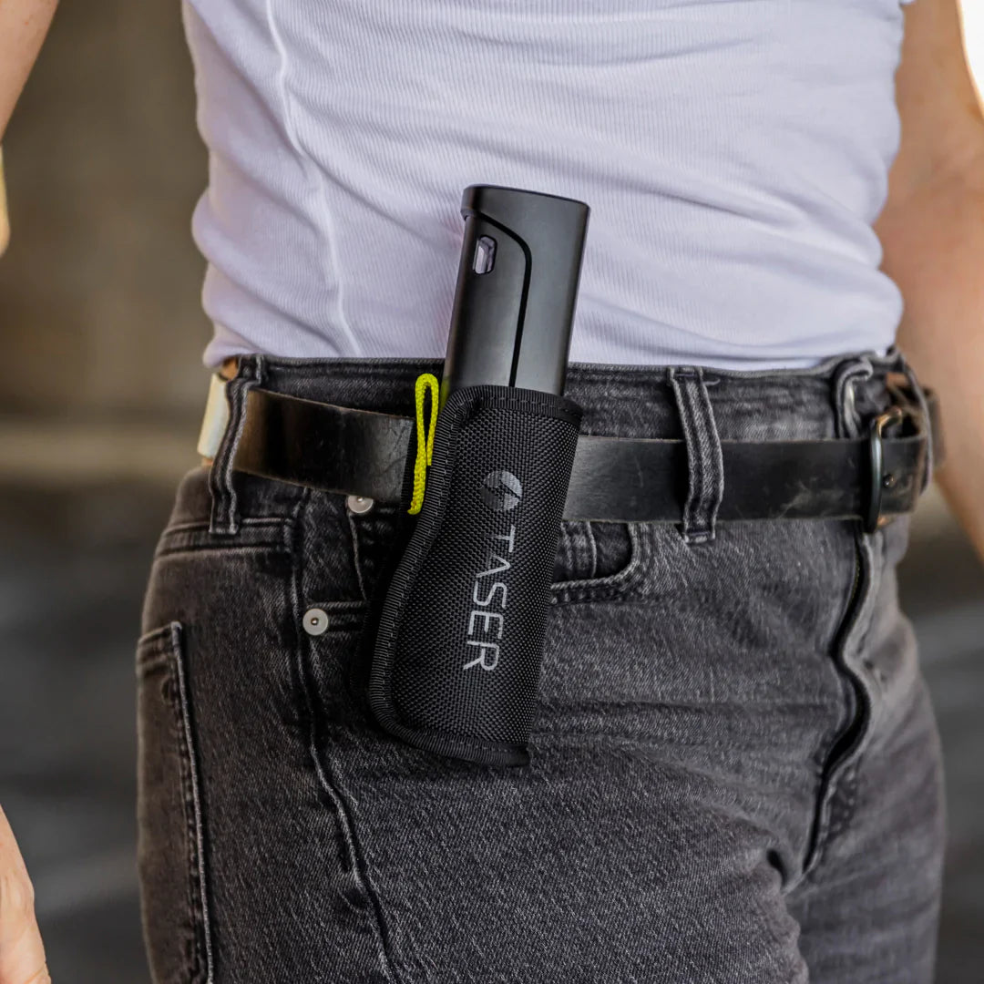 Someone carrying TASER StrikeLight 2 Kit – versatile self-defense flashlight featuring a 700-lumen beam, built-in stun capability, audible arc warning, and USB-C charging for everyday protection.