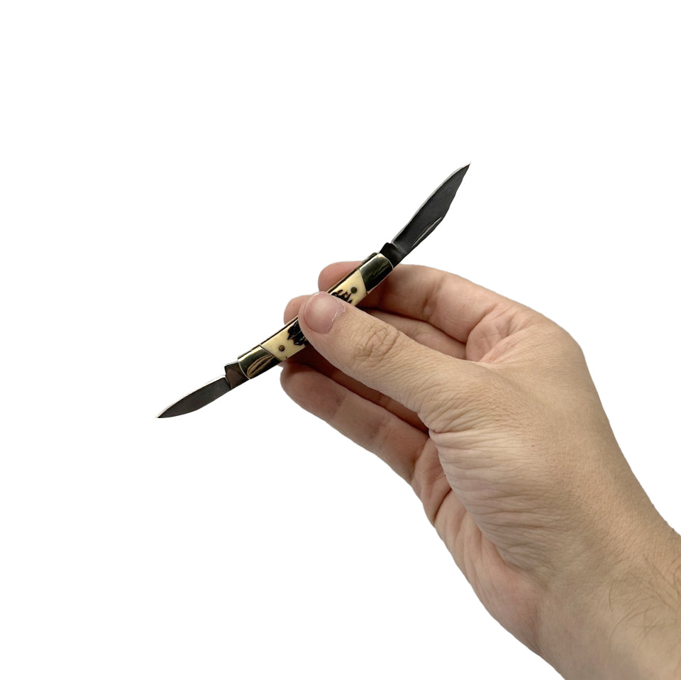 Someone holding 2.5″ Manual Folding Knife – compact pocket knife with a stainless steel drop-point blade and simple manual opening, perfect for everyday carry and light-cutting tasks, in white background.