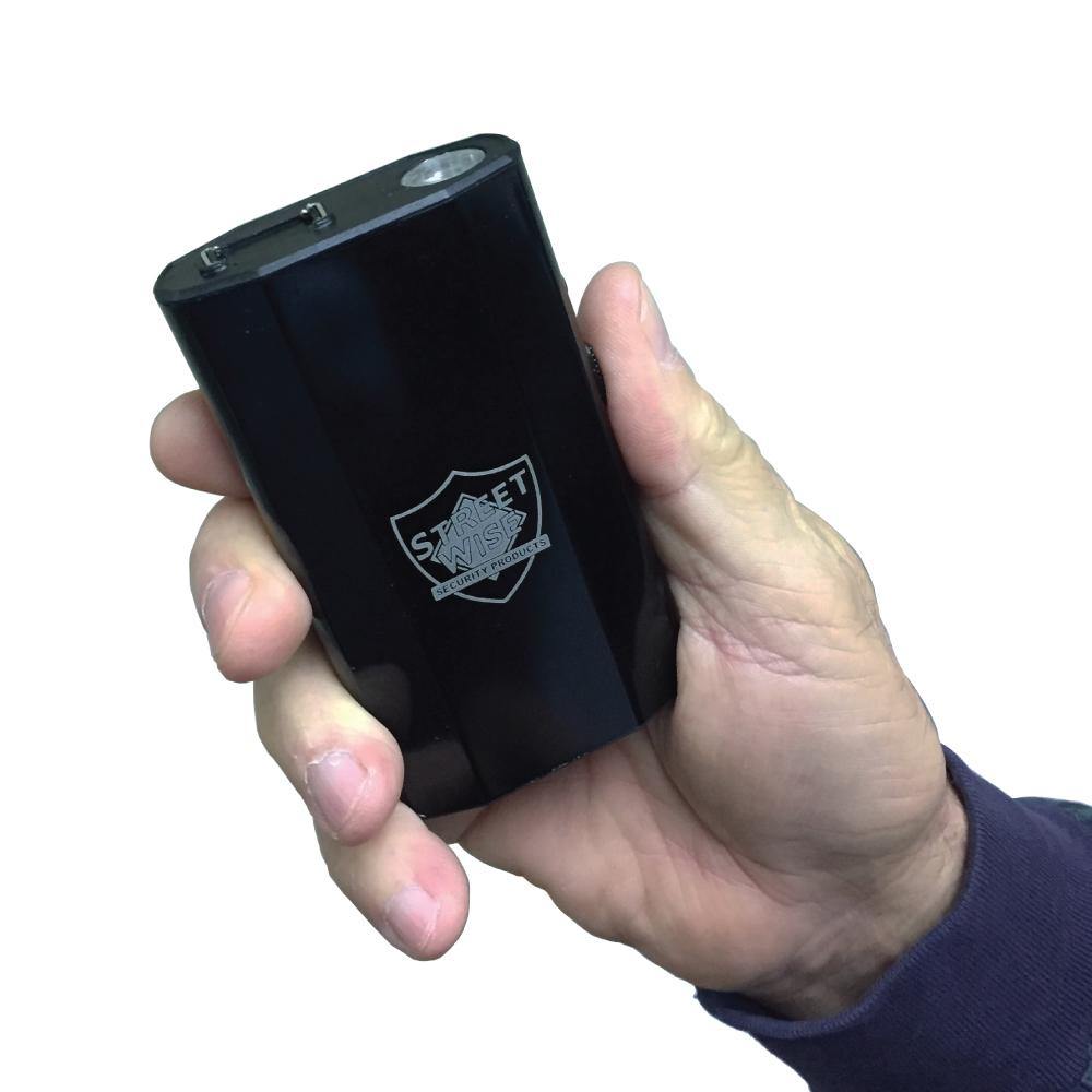 Someone holding 3-N-1 28,000,000* Stun Gun - multifunctional self-defense device combining a stun gun, flashlight, and safety alarm for maximum personal protection, in white background.