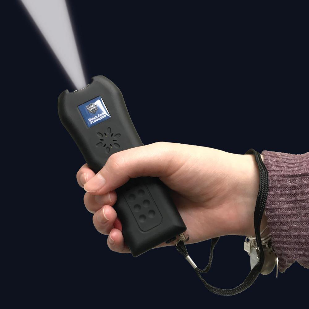 Someone holding Black Jack 21,000,000 Stun Gun - powerful and compact self-defense tool with an ergonomic grip, designed for quick access and reliable stopping power, in black background.