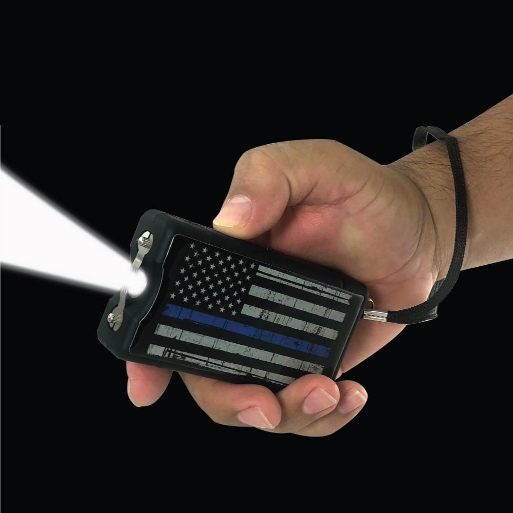Blue Line 9,000,000 Stun Gun - Someone holding compact and reliable self-defense tool featuring a high-voltage charge and a design honoring law enforcement support, in  black background.