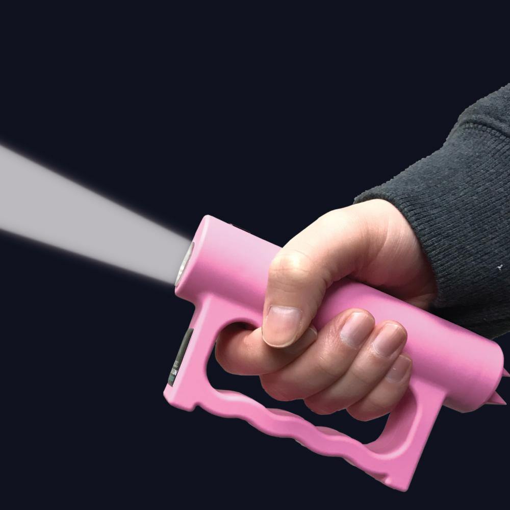 Someone holding Double Down 23,000,000* Stun Gun - powerful dual-contact stun device designed for maximum stopping power and reliable personal protection, in dark background.