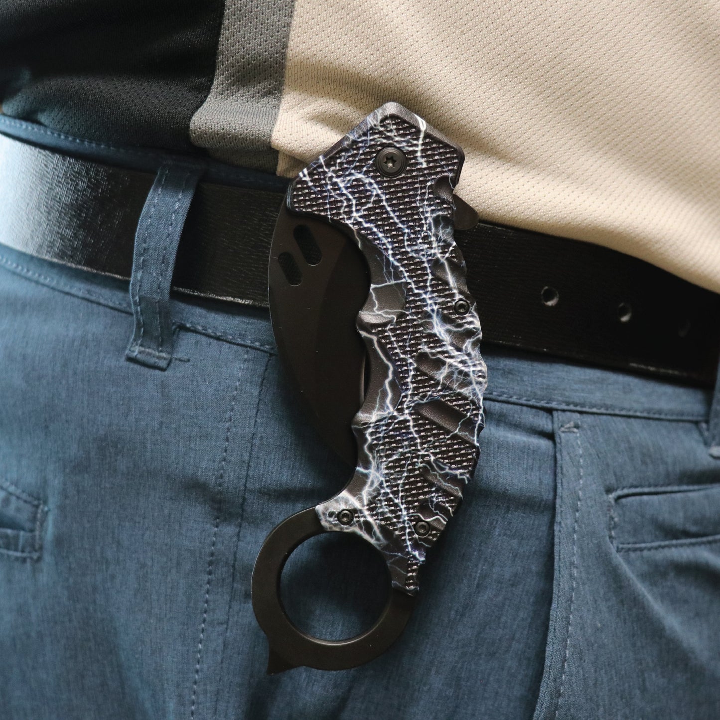 Someone carrying Karambit 5.25" Knife - curved blade folding knife designed for tactical use, featuring an ergonomic handle and a secure grip for self-defense.
