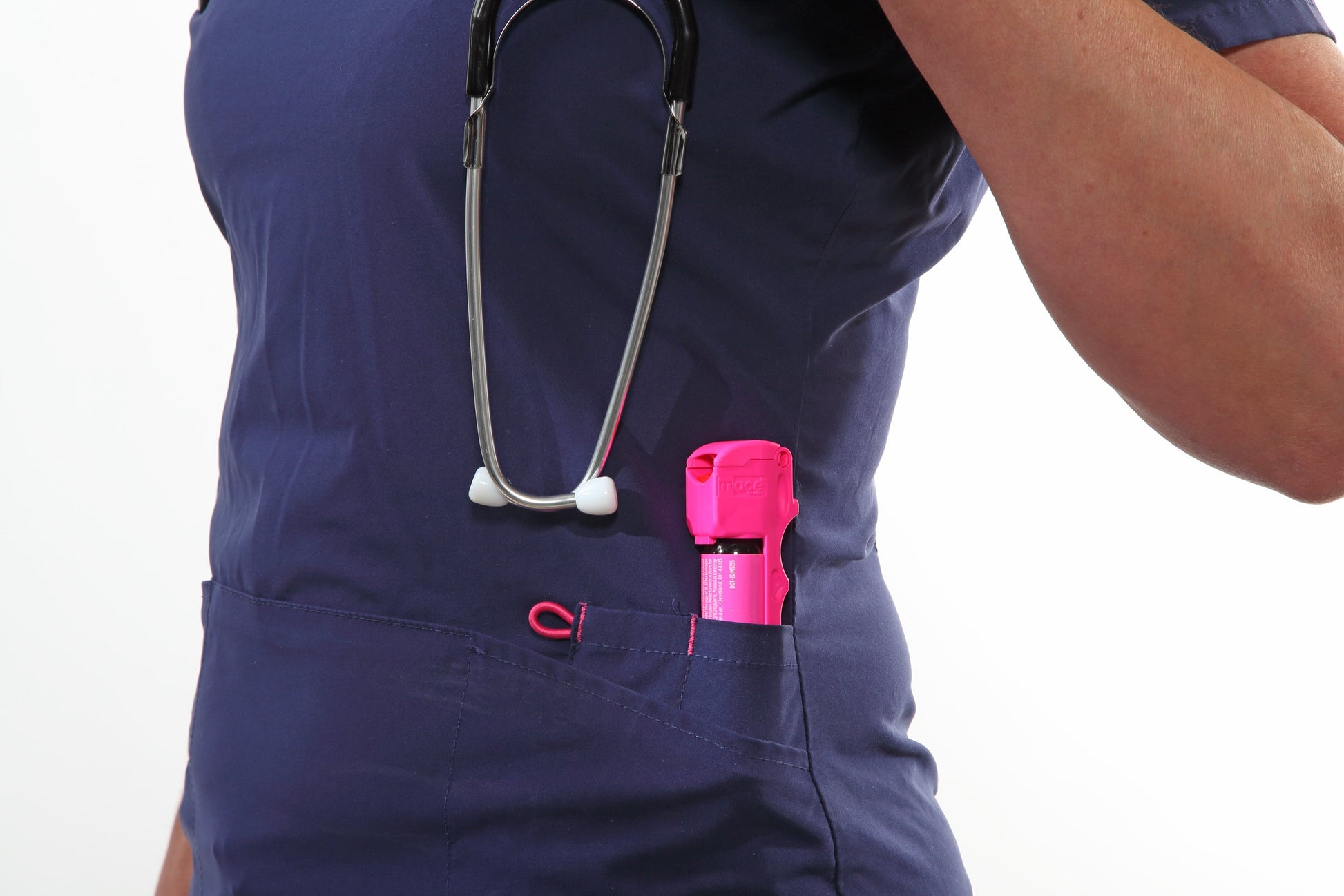 Someone carrying Mace Pocket Model Stream Pepper Spray – compact self-defense spray with a focused stream pattern delivering up to 10 ft of range, flip-top safety cap, finger-grip design, and UV dye for attacker identification, in white background.