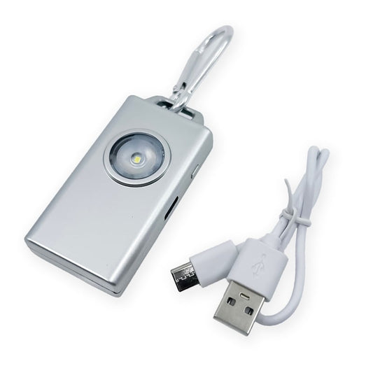 Micro Guard™ Plus Personal Alarm with COB LED Flashlight – compact personal safety device combining a 130 dB alarm and a COB LED floodlight, featuring a keychain loop and USB‑C rechargeable battery for everyday carry, in white background.