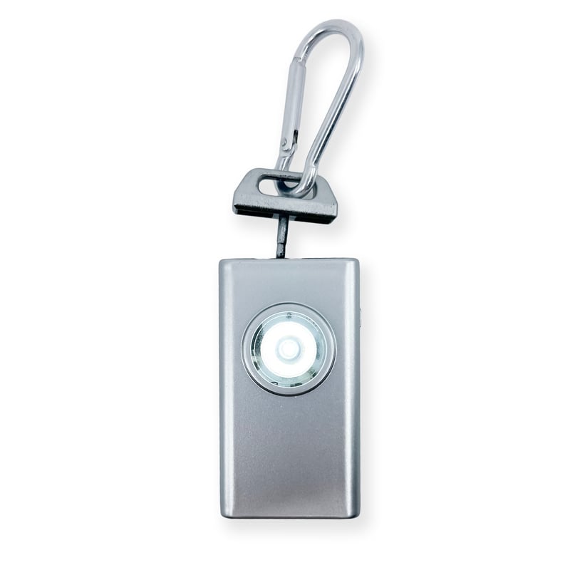 Micro Guard™ Plus Personal Alarm with COB LED Flashlight – compact personal safety device combining a 130 dB alarm and a COB LED floodlight, featuring a keychain loop and USB‑C rechargeable battery for everyday carry, in white background.