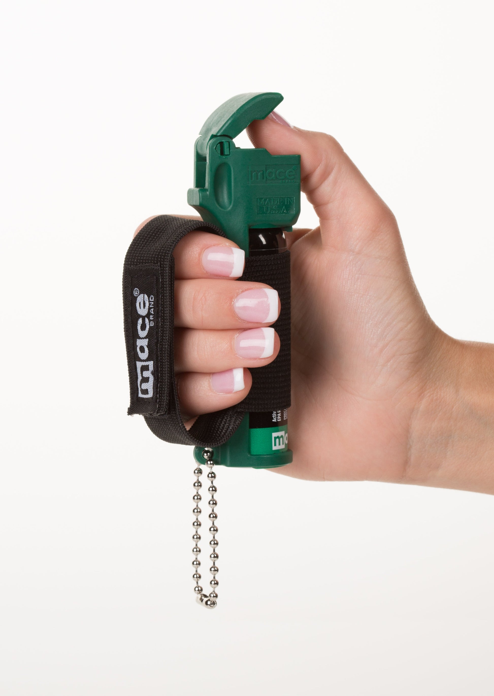 Someone holding Muzzle Dog Repellent Pepper Spray – compact, canine-safe pepper spray with a stream delivery system reaching up to 10 ft, flip-top safety cap, finger-grip design, keychain attachment, and adjustable strap for hands-free use during walks or jogging., in white background.