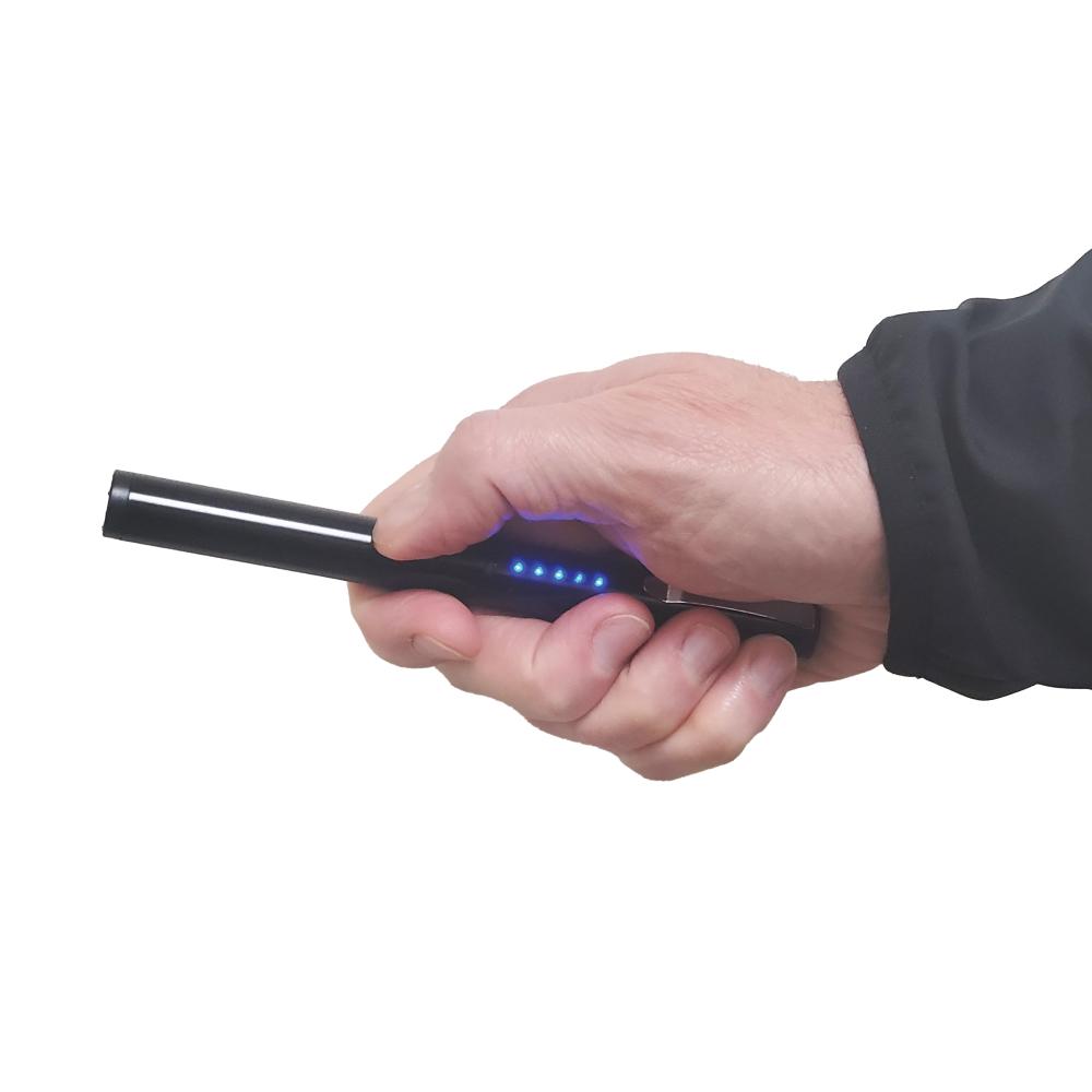 Someone holding a Pain Pen 25,000,000 Stun Gun - a discreet and compact self-defense device designed to look like a pen, ideal for personal protection, in white background.