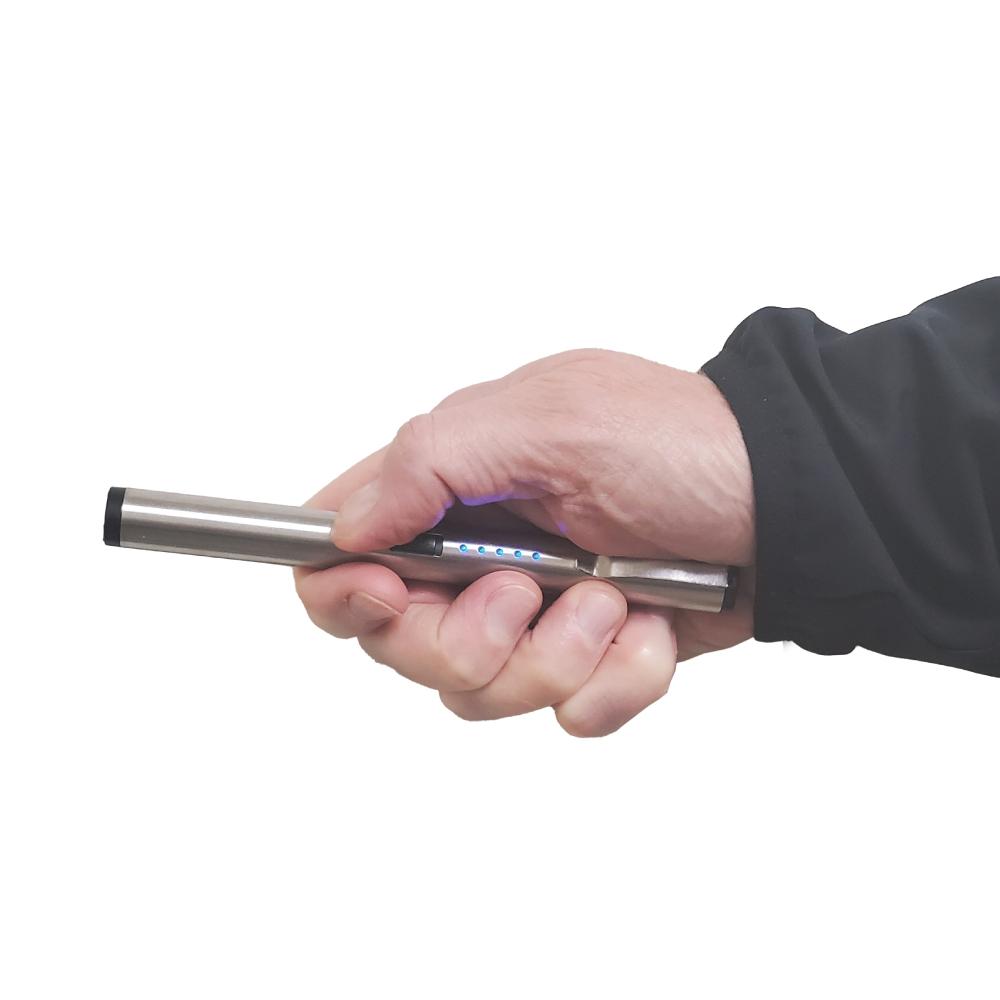 Someone holding a Pain Pen 25,000,000 Stun Gun - a discreet and compact self-defense device designed to look like a pen, ideal for personal protection, in white background.