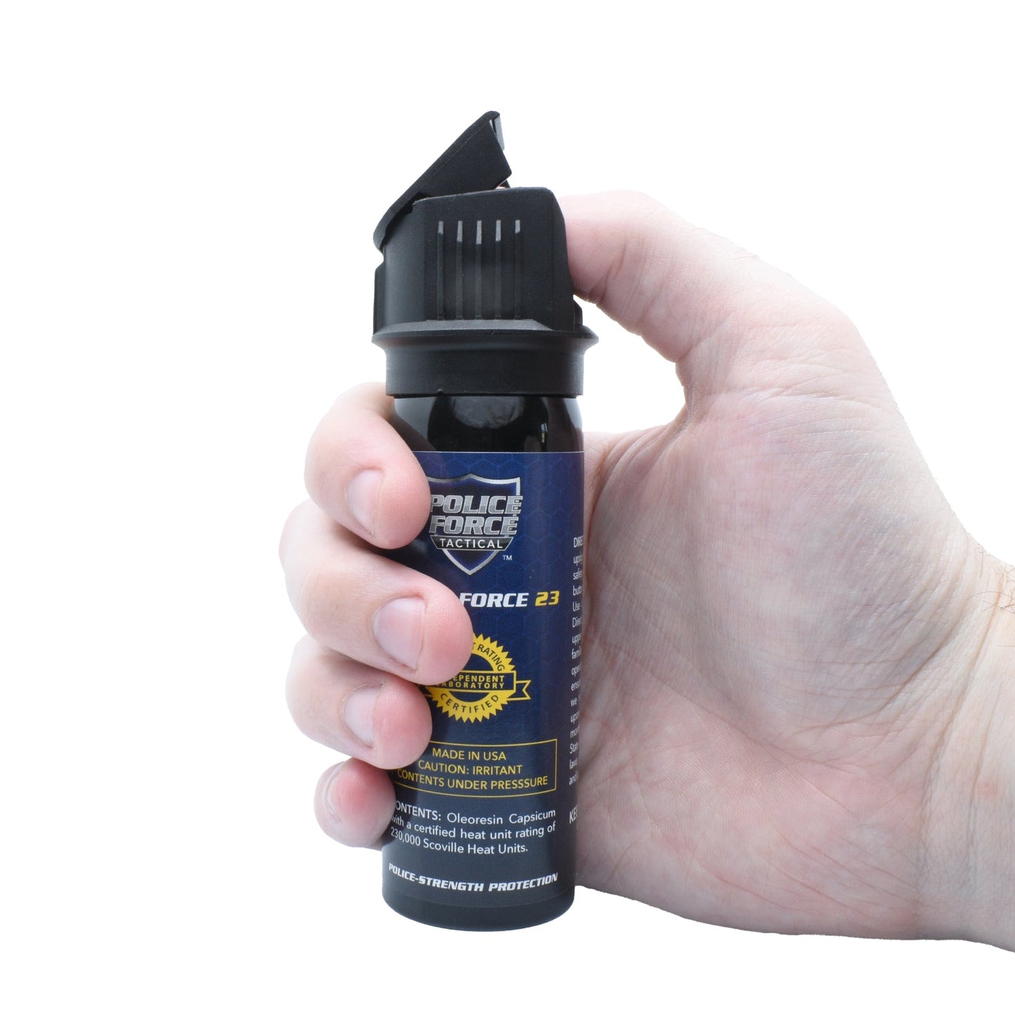 Someone holding Police Force 23 stream pepper spray with flip top safety cap - compact personal defense spray, on white background.