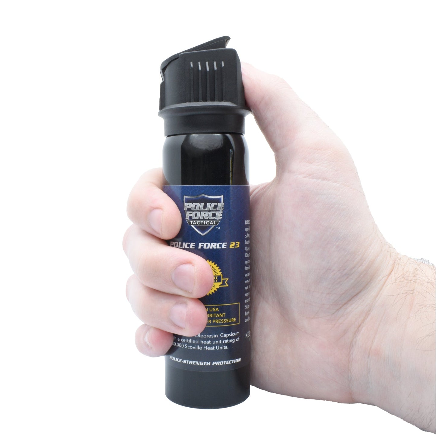 Someone holding Police Force 23 stream pepper spray with flip top safety cap - compact personal defense spray, on white background.