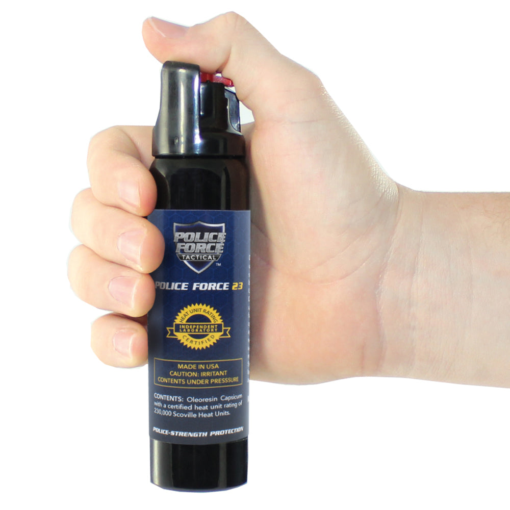 Someone holding Police Force 23 Stream Pepper Spray with Twist Lock – compact self-defense spray featuring a twist-lock safety mechanism and a focused stream delivery for precise targeting and reduced blowback, in white background.