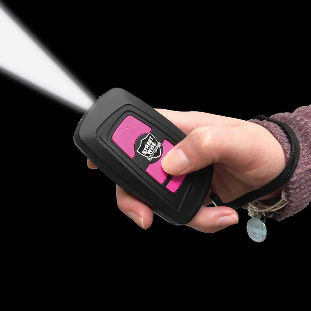 Someone holding Razoer 23,000,000 Stun Gun - sleek and powerful self-defense tool with a slim design, combining high voltage output with easy protability, in black background.