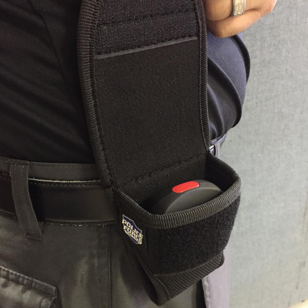 Someone carrying Sting Ring Holster - custom-fit carrying case designed to securely hold and protect the Sting Ring stun gun for quick and easy access, in white background.