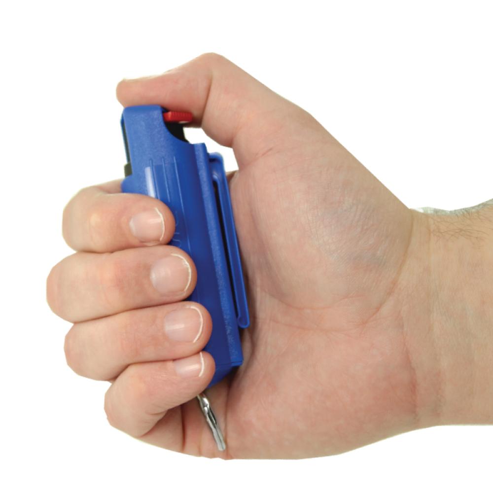 Someone holding Streetwise 18 Stream Pepper Spray in 0.5oz Hard Case - compact personal defense spray with safety lock, in white background.