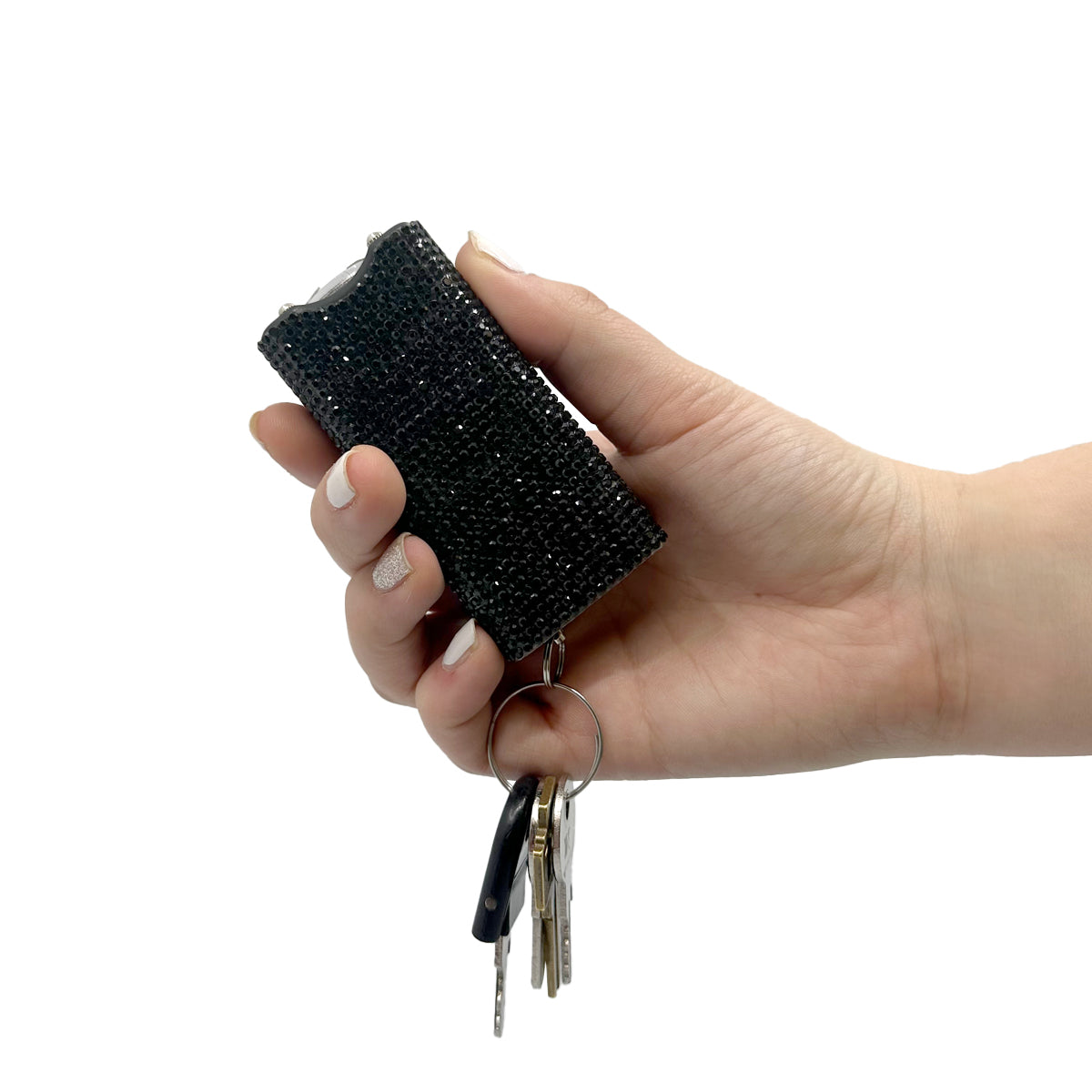 Someone holding Streetwise Rhinestun Keychain Stun Gun – compact mini stun gun with stylish rhinestone exterior, built-in LED flashlight, micro-USB rechargeable battery, dual-safety switch, keyring attachment, and nylon holster; delivers powerful high-voltage shock in a fashion-forward design, with keys, in white background.