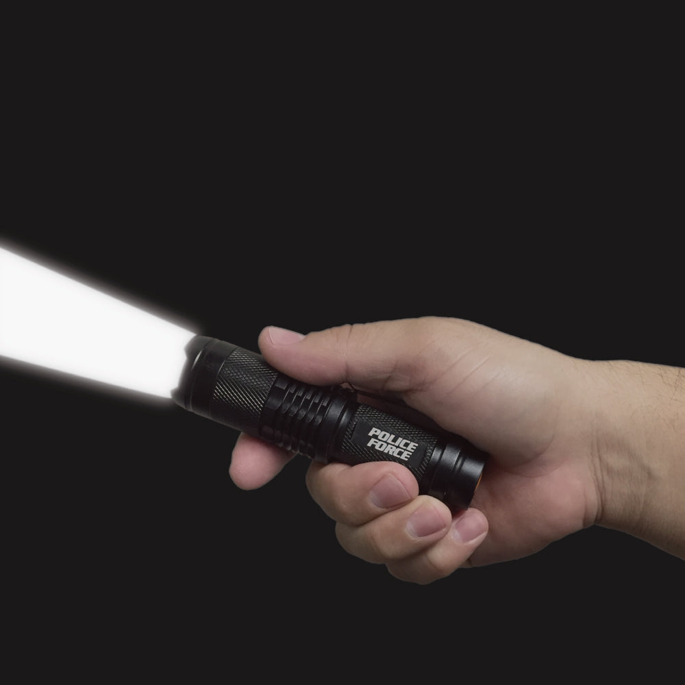 Someone holding Tactical T6 LED Flashlight – high-intensity flashlight with T6 LED technology, designed for superior brightness and durability in tactical and outdoor use, in dark background.
