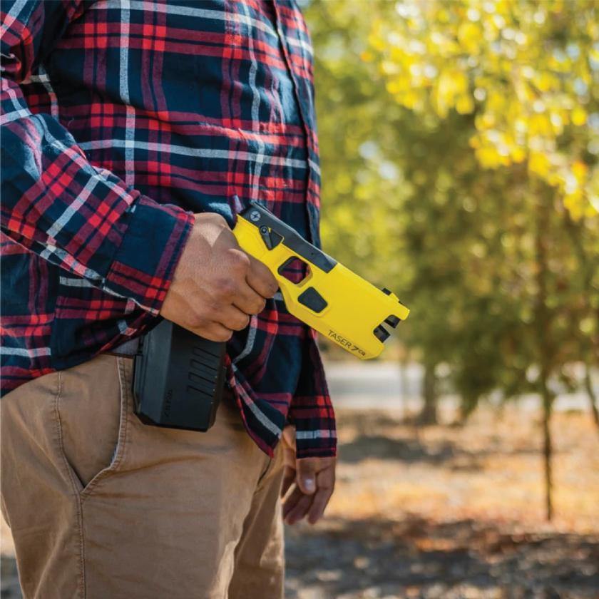 Someone holding Taser 7 CQ - close-quarters conducted energy weapon designed for law enforcement and personal defense, providing effective stopping power at short range.