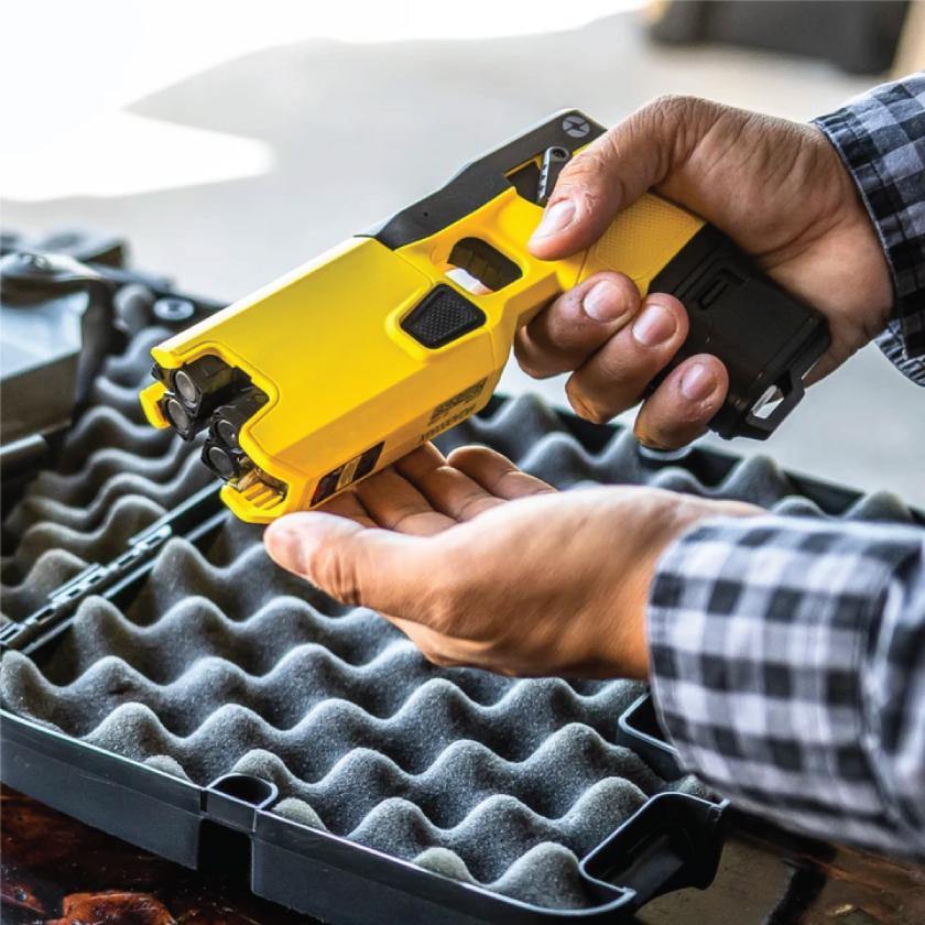 Someone holding Taser 7 CQ - close-quarters conducted energy weapon designed for law enforcement and personal defense, providing effective stopping power at short range.