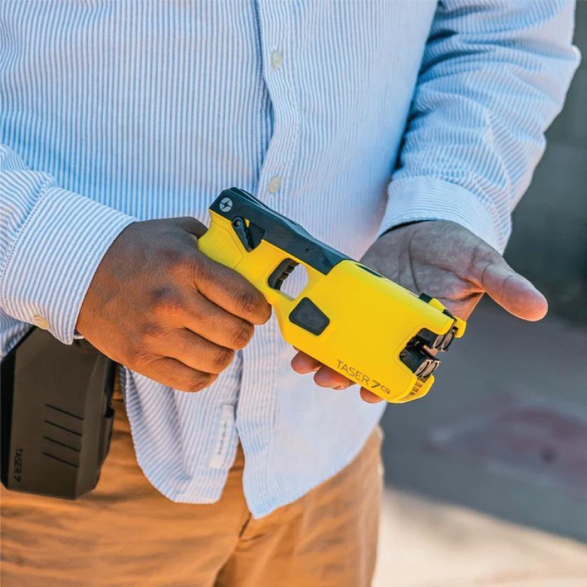 Someone holding Taser 7 CQ - close-quarters conducted energy weapon designed for law enforcement and personal defense, providing effective stopping power at short range.