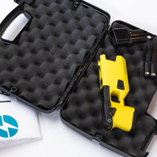 Taser 7 CQ on case - close-quarters conducted energy weapon designed for law enforcement and personal defense, providing effective stopping power at short range, in white background.