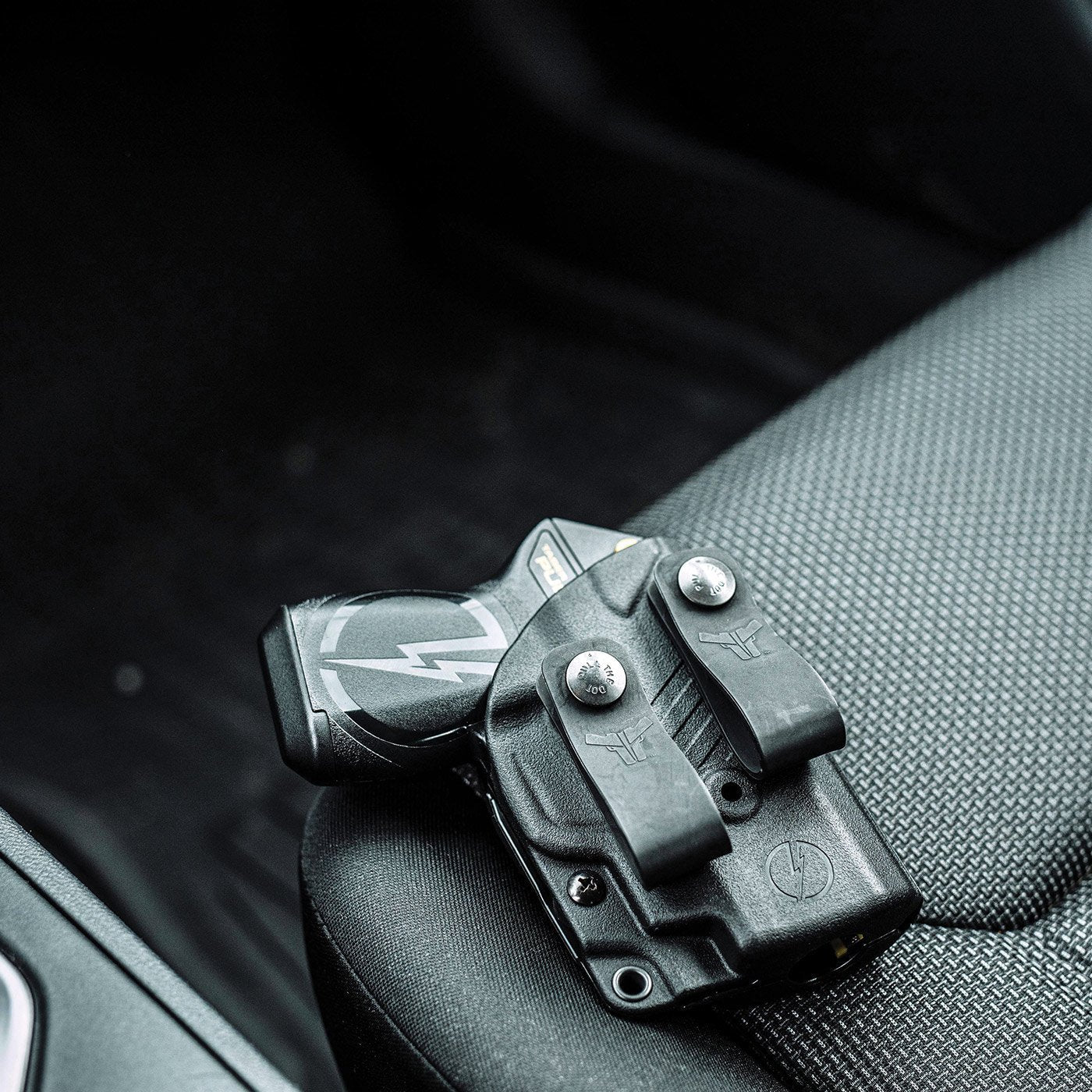 Taser Pulse Holster - inside-the-waistband (IWB) holster designed for concealed and comfortable carrying of the Taser Pulse self-defense device, on a car seat.