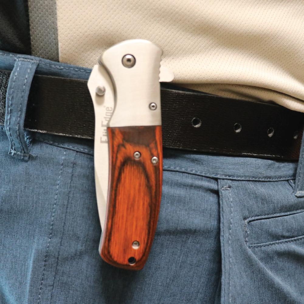Someone carrying Woodgrain 8-inch premium folding knife with textured handle, ideal for collectors and outdoor use.